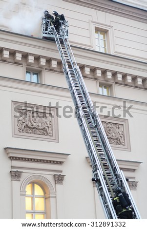 MOSCOW - December 8, 2014: Firefighters at the fire stairs rise to the burning window of State Academic Bolshoi Theatre of Russia Historical scene