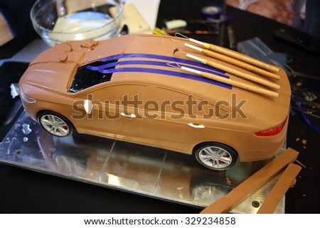 RUSSIA, MOSCOW -?? 4 DEC, 2014: Ford car model made of clay with tools on the roof.