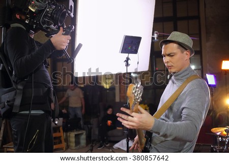 Professional video shooting a musician playing the guitar in the studio Сток-фото © 