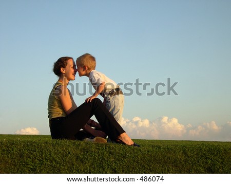 mother with son on sundown kiss by nose