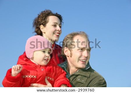 family with baby face on spring sky