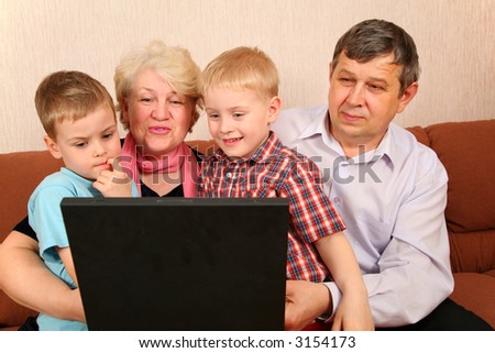 grandparents with grandchildren with notebook