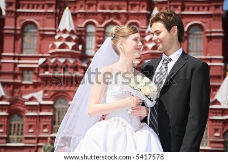 fiance and bride against the background of historical museum in Moscow