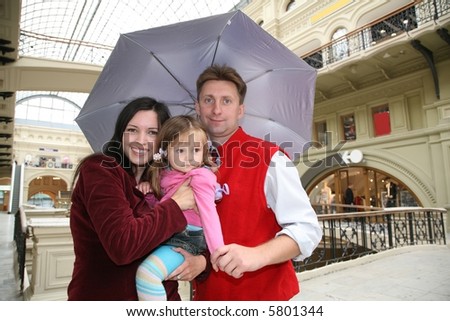 family in shop ith umbrella