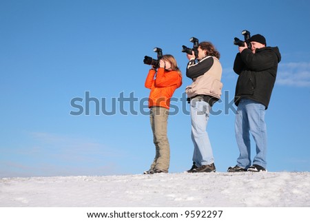 three photographers on snow hill