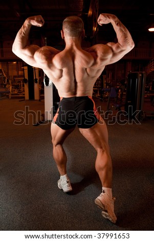 bodybuilder back demonstrates his muscles