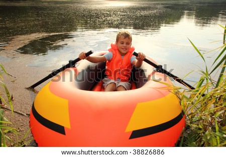 boy in inflatable boat in water
