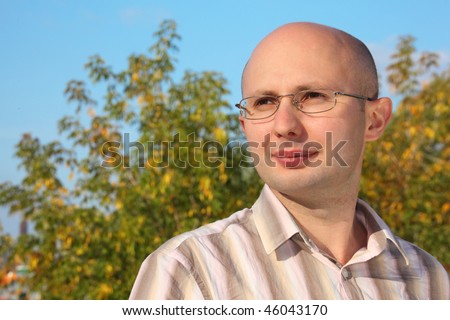 portrait of man in early fall park.he is looking away