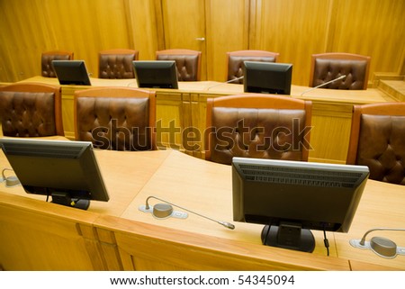 Conference halls with magnificent leather armchairs and wooden tables with microphones and monitors, Foreshortening from above