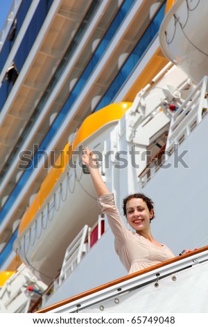 Smiling girl on ladder goes to cruise ship and wave by straight hand
