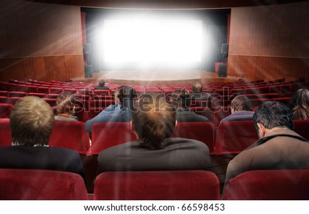 spectators in hall of cinema with movie collage