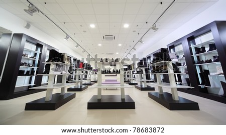 Black Shelves With Many Boots And Shoes Into Large Shoe Store Stock ...