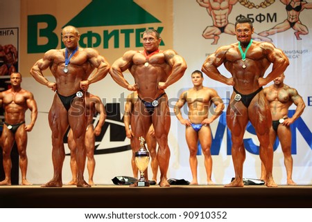 MOSCOW - APRIL 16: Andrei Popov, Dmitry Karakash, Igor Ivanov are winners in category of 100 kg at Open Cup of bodybuilding and fitness of Moscow in hotel Cosmos on April 16, 2011 in Moscow, Russia.