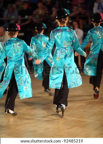 MOSCOW - MAY 4: Back of girls dance step at IX World Dance Olympiad in Sokolniki, on May 4, 2011 in Moscow, Russia. 21 305 dancers from 31 countries and 165 cities participated in Olympiad.
