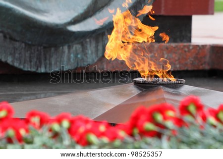 Flowers at memorial to tomb of Unknown Soldier in Alexander Garden at Victory Day; Eternal Flame