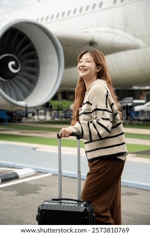 Similar – Image, Stock Photo Female passenger carrying the hand luggage bag, walking the airplane boarding corridor.