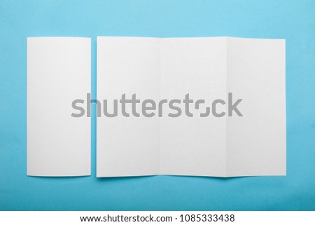 blank trifold paper brochure with shadows on white blank trifold