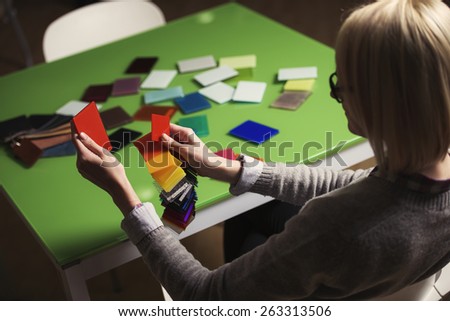 a young business woman is matching color samples