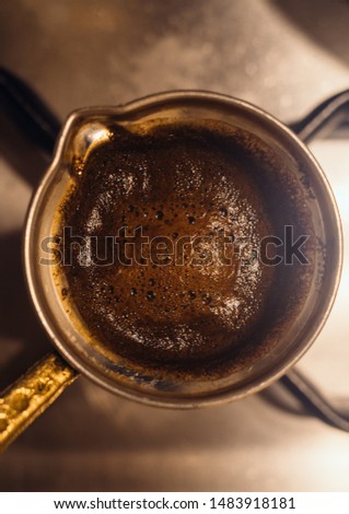 Similar – Image, Stock Photo Turkish espresso pot made of hammered metal stands for coffee preparation on the gas flame of the kitchen stove