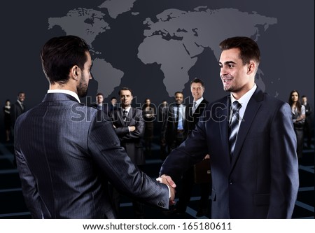 Portrait of young business people. Handshake in front of business people