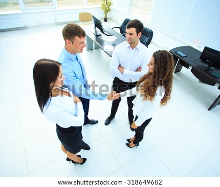 Top view of business people shaking hands, finishing up a meeting - Welcome to business