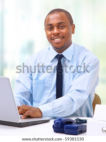 Portrait of a handsome young business man with a laptop