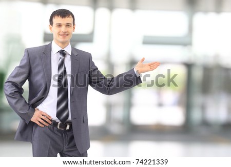 Happy business man showing something on the palm of his hand