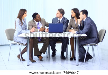 Leader with his successful team discussing in conference room