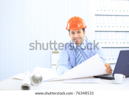 Site manager in the office with helmet