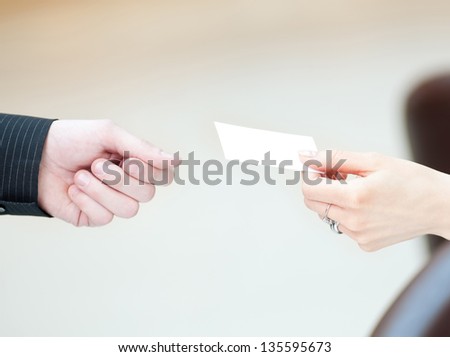 Concept shot of exchange business card between man and  woman. Partnership