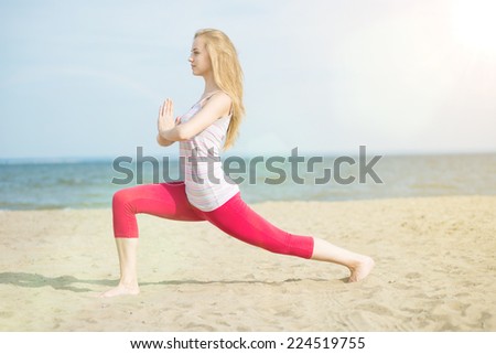 Young lady practicing yoga. Beautiful woman posing at sand beach. Workout near ocean sea coast. Beautiful fit tan girl. Fitness model caucasian ethnicity outdoors. Weight loss exercise. Meditation.