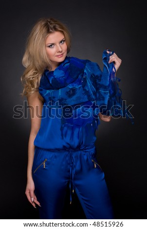 Closeup portrait of beautiful fashion woman in blue suit with flying scarf