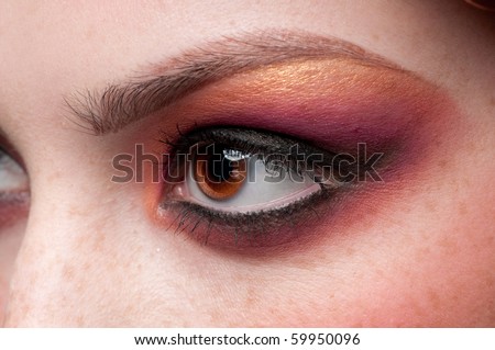 Closeup eyes make-up zone. Purple and golden color. High resolution.