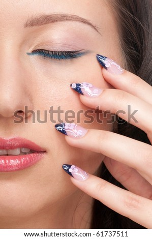 Close-up portrait of beauty woman face with perfect skin. Nail art