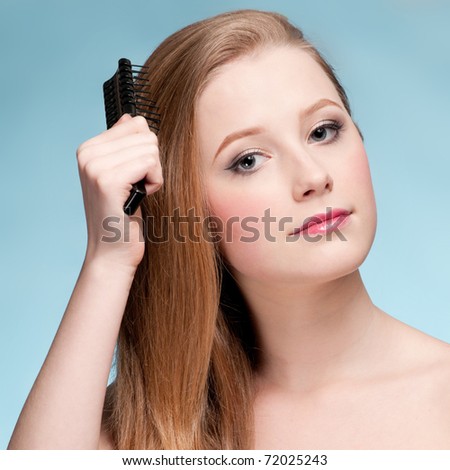 Close up portrait of young beautiful woman that comb perfect hair