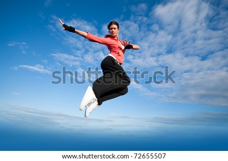 Beautiful sport woman in urban sportswear jumping and fly over blue sky with clouds