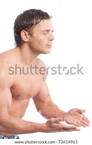 Young man wash face. Water drop and spash