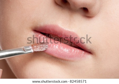 Close-up face of beauty young woman - lips make-up zone