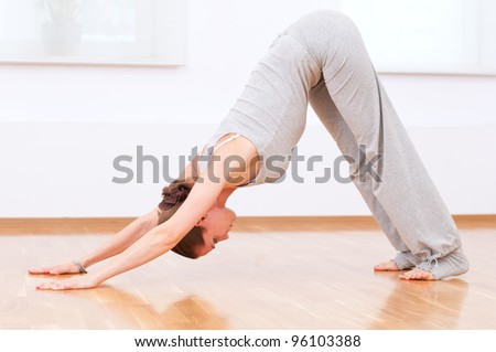 Beautiful sport woman doing stretching fitness exercise at sport gym. Yoga