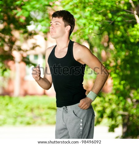Young man jogging in park. Health and fitness.