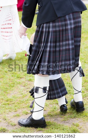 detail of man and child wearing kilt, Scotland