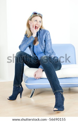 woman wearing blue clothes sitting on sofa