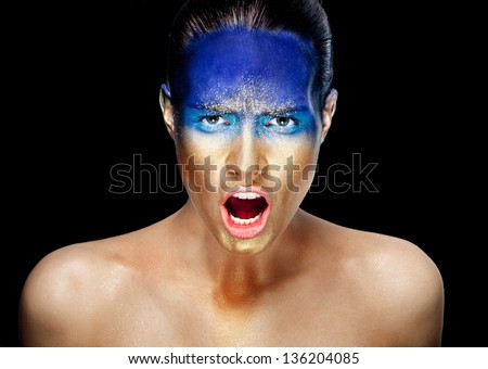 Portrait of screaming woman with golden face