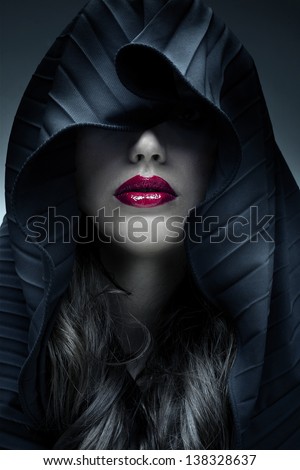 Portrait of mysterious woman in dark hood