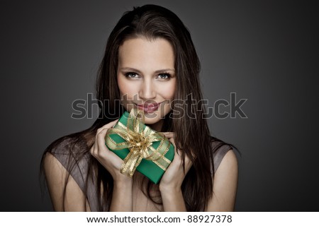 Portrait of beautiful girl with christmas gift
