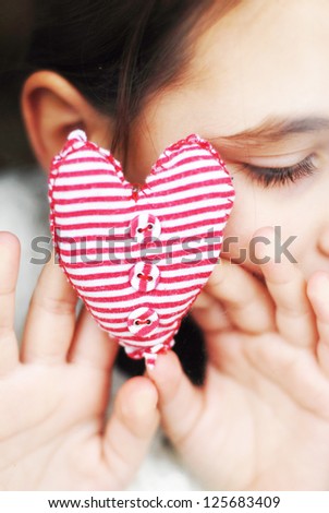 little girl gives a heart