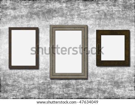 Three empty frames on a grey old wall