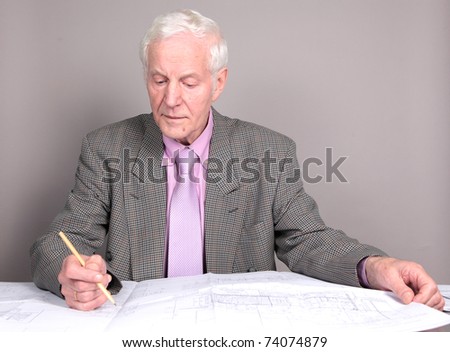 Old man studying project. isolated against grey background