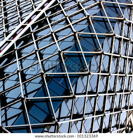Complex building structural detail, blue metal bars and glass