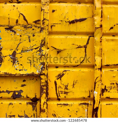 Industrial Metalic container of Yellow paint, scratched and rusted up